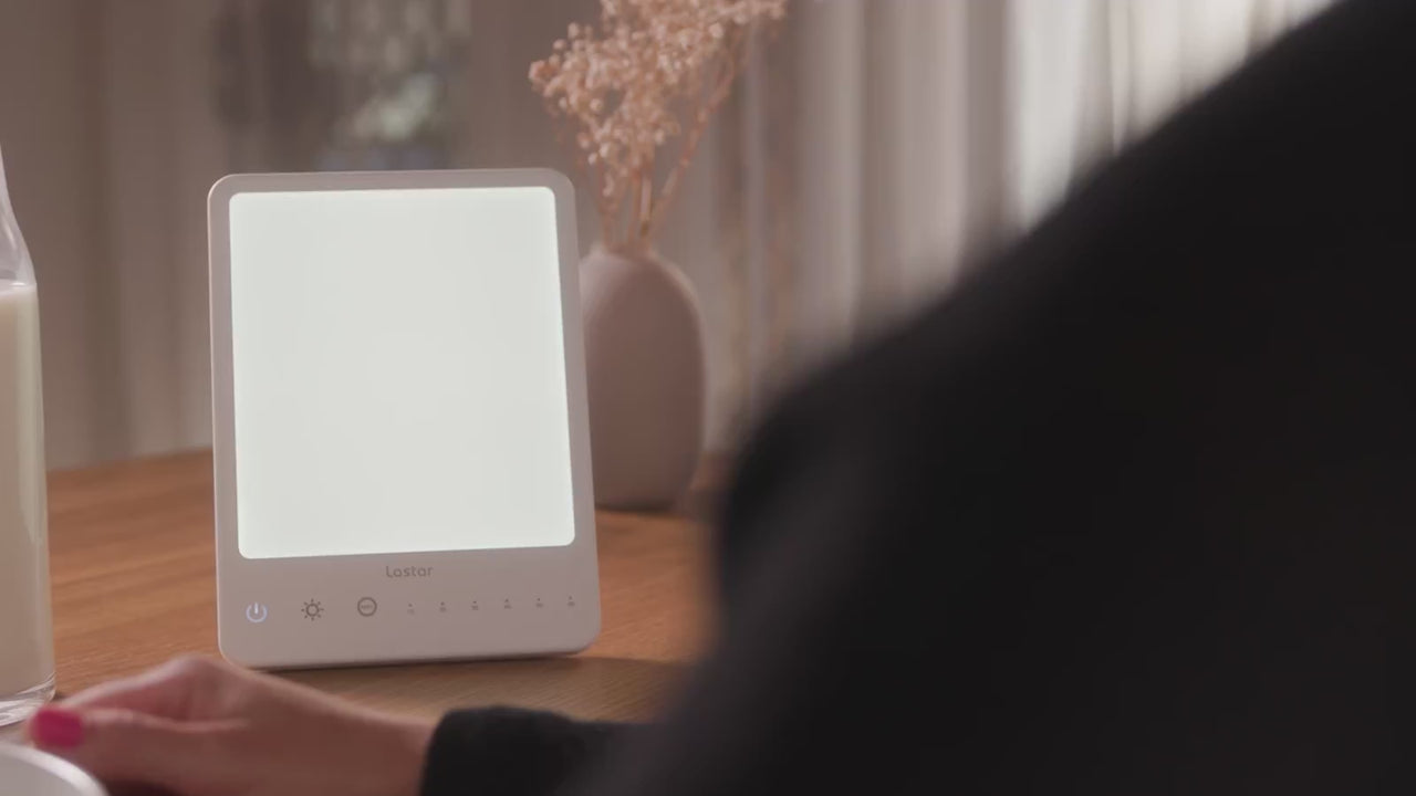 LASTAR light therapy lamp glowing on a breakfast table