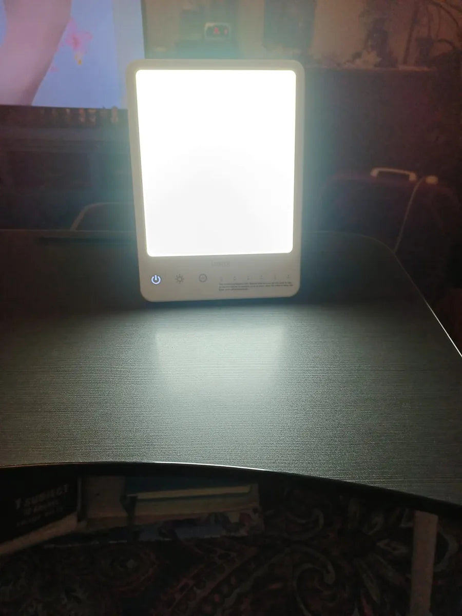 A LASTAR Squaresun lamp shining brightly on a dark desk